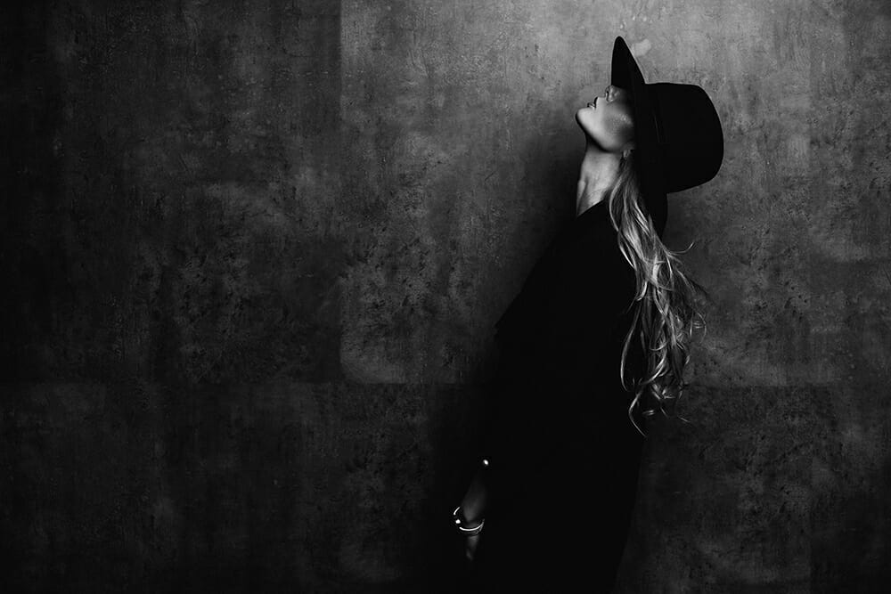 female model black and white monochrome hat dark glasses looking up profile
