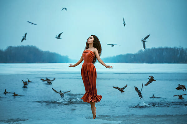 model levitation photography floating water orange dress blue water birds