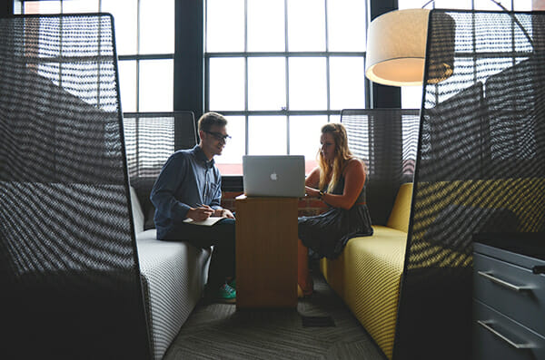 male and female giving feedback around laptop 2 Feedback