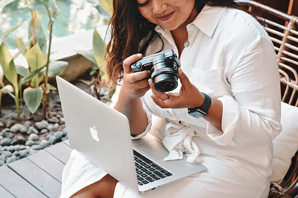 female looking at back of camera with laptop on knees Feedback